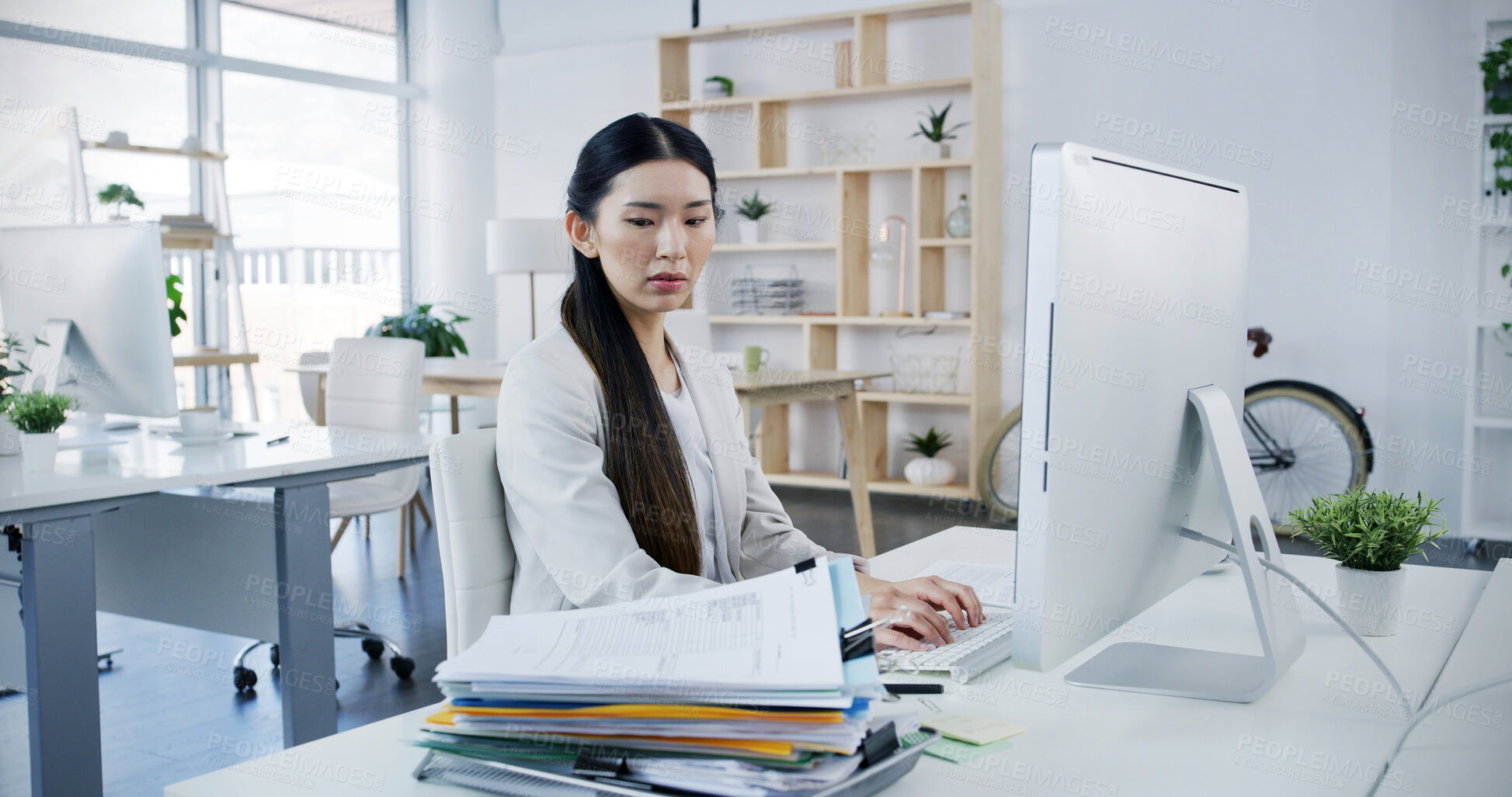 Buy stock photo Documents, office and business Asian woman on computer for online project, website and overworked. Workload, corporate and person on pc worry with paperwork for research, deadline and administration