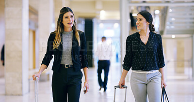 Buy stock photo Business women, talk and walking with luggage for travel, work trip and partnership in airport lobby. Employees, friends and suitcase for international opportunity, journey and project collaboration