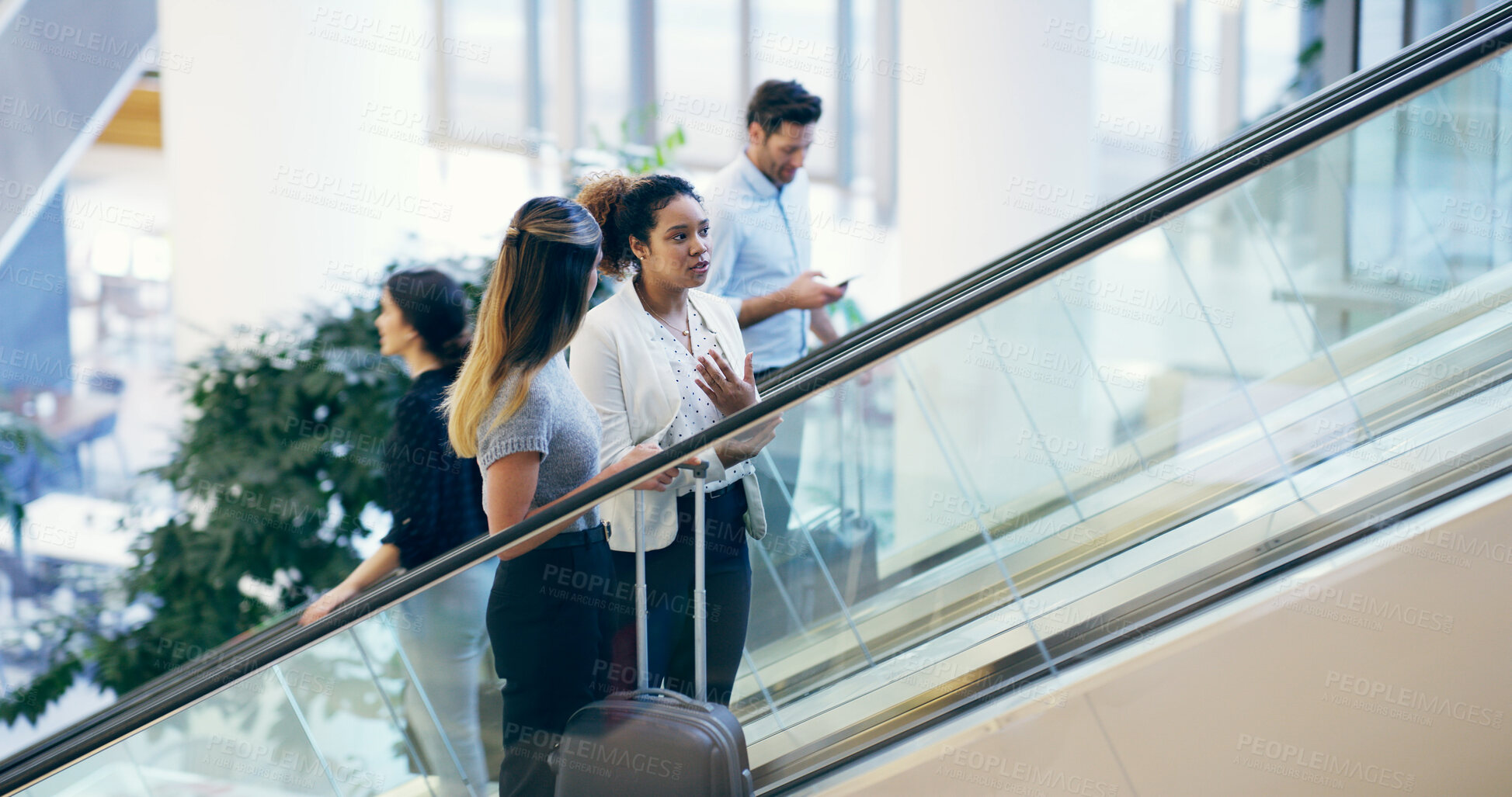 Buy stock photo Business people, escalator and travel at airport with suitcase for flight, international journey and brokers chat. Team trip, workers and luggage at lobby for arrival, immigration and women talking