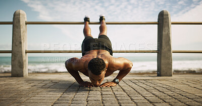 Buy stock photo Fitness, man and push up at ocean for exercise, balance and upper body workout. Bodybuilder, training and muscular person on beach promenade with commitment, endurance and intense activity for sport