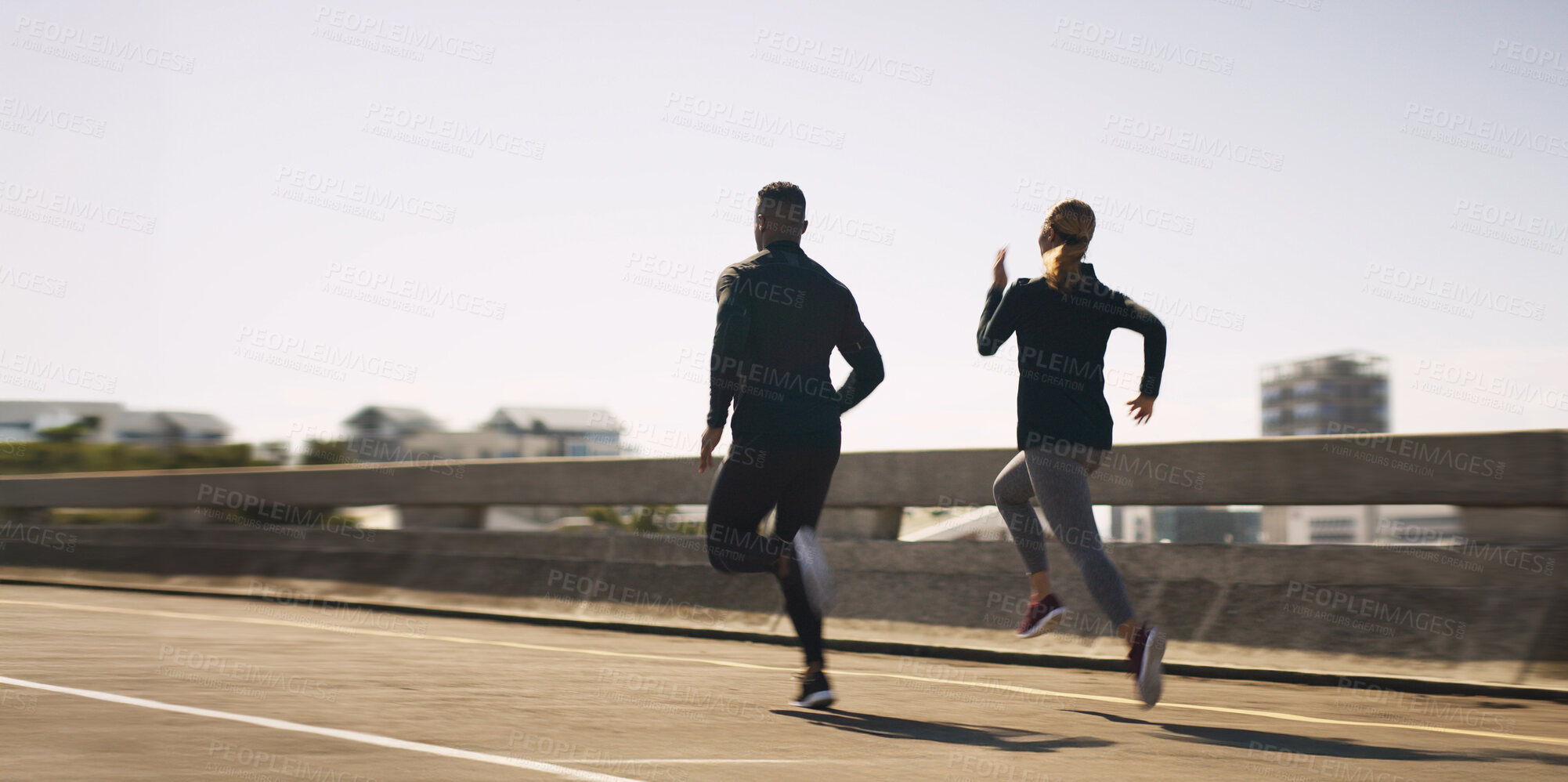 Buy stock photo Outdoor, couple of friends and running for fitness in bridge for health, wellbeing and self care. City, people and jog with support or care for exercise, training and workout on highway road