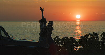 Buy stock photo Sunset, couple and freedom by beach on road trip with hugging, travel adventure or summer memory. Silhouette, lesbian people or view of ocean by car on weekend vacation and bonding together in nature