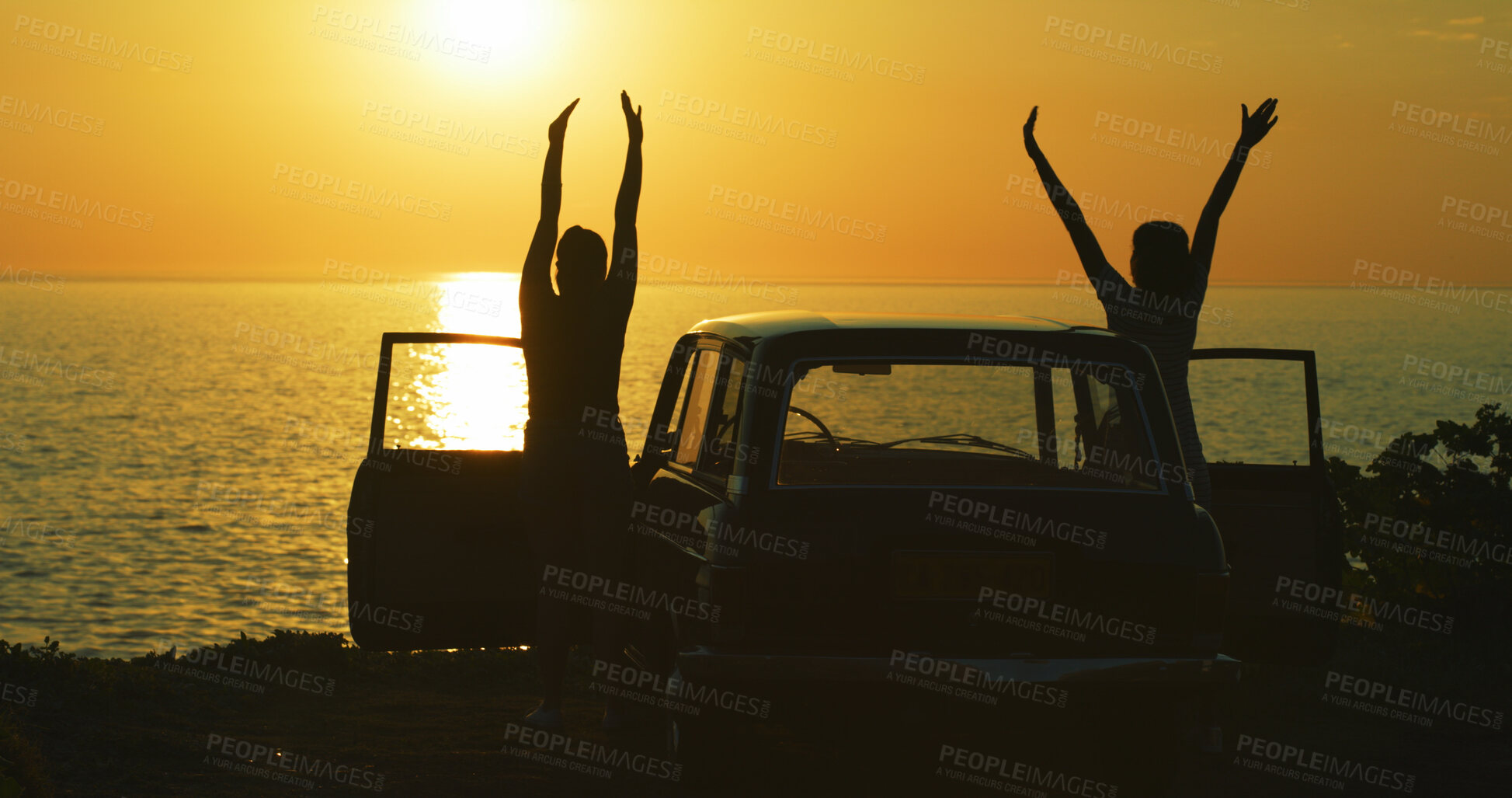 Buy stock photo Couple, silhouette and sunset at beach for road trip, freedom and excited for journey in nature. People, friends and shadow at car for travel, adventure and outdoor for memories at California ocean