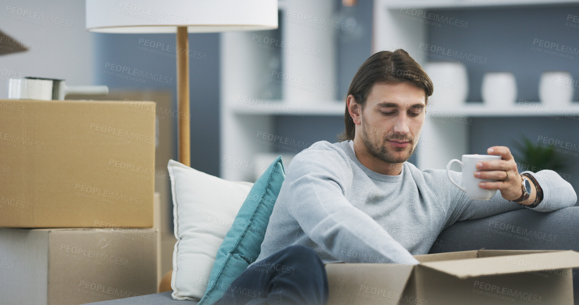 Buy stock photo Man, living room and coffee for boxes, packing and moving in new house as college student. Male person, cardboard and spring cleaning as social responsibility, outreach and donation with hot beverage