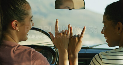 Buy stock photo Friends, road trip and horns sign on travel, hands and together for journey, connection and excited in car. Women, people and transport with driving on vacation with icon, symbol and emoji in street