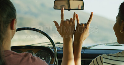 Buy stock photo Hands, road trip and horns sign with car, love and together for travel, connection and kindness on journey. People, driving and transport with friends on vacation with icon, symbol or emoji in street