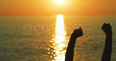 Buy stock photo Sunset, freedom and hands of person at beach for summer vacation, travel and ocean view. Success, celebration and holiday with silhouette of fist pump in nature for mockup, explore and tourism trip