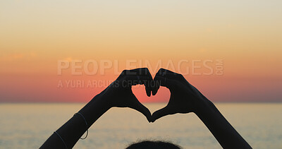 Buy stock photo Person, outdoor beach and heart hands at sunset, love and emoji for kindness on earth adventure. Horizon, dusk and fingers for gesture on vacation at sea, support ecology and care for tropical island