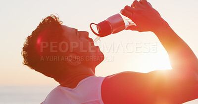 Buy stock photo Man, fitness and drinking with water bottle in sunset for hydration, mineral liquid or refreshment. Active, male person or runner with lens flare, aqua beverage or thirst for natural sustainability