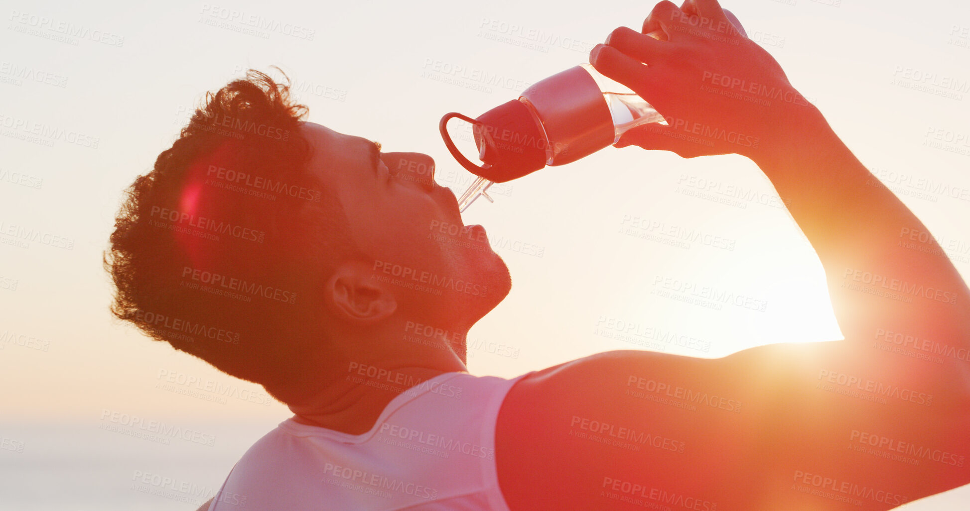 Buy stock photo Man, fitness and drinking with water bottle in sunset for hydration, mineral liquid or refreshment. Active, male person or runner with lens flare, aqua beverage or thirst for natural sustainability