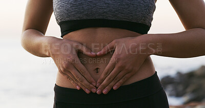 Buy stock photo Woman, hands and fitness with stomach for gut health, balance or belly wellness in nature. Closeup, female person or tummy with good digestion for healthcare, training or workout by beach or ocean