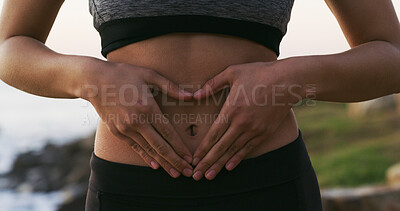 Buy stock photo Woman, hands and balance with stomach for gut health, fitness or belly wellness in nature. Closeup, female person or tummy with good digestion for healthcare, training or workout by beach or ocean