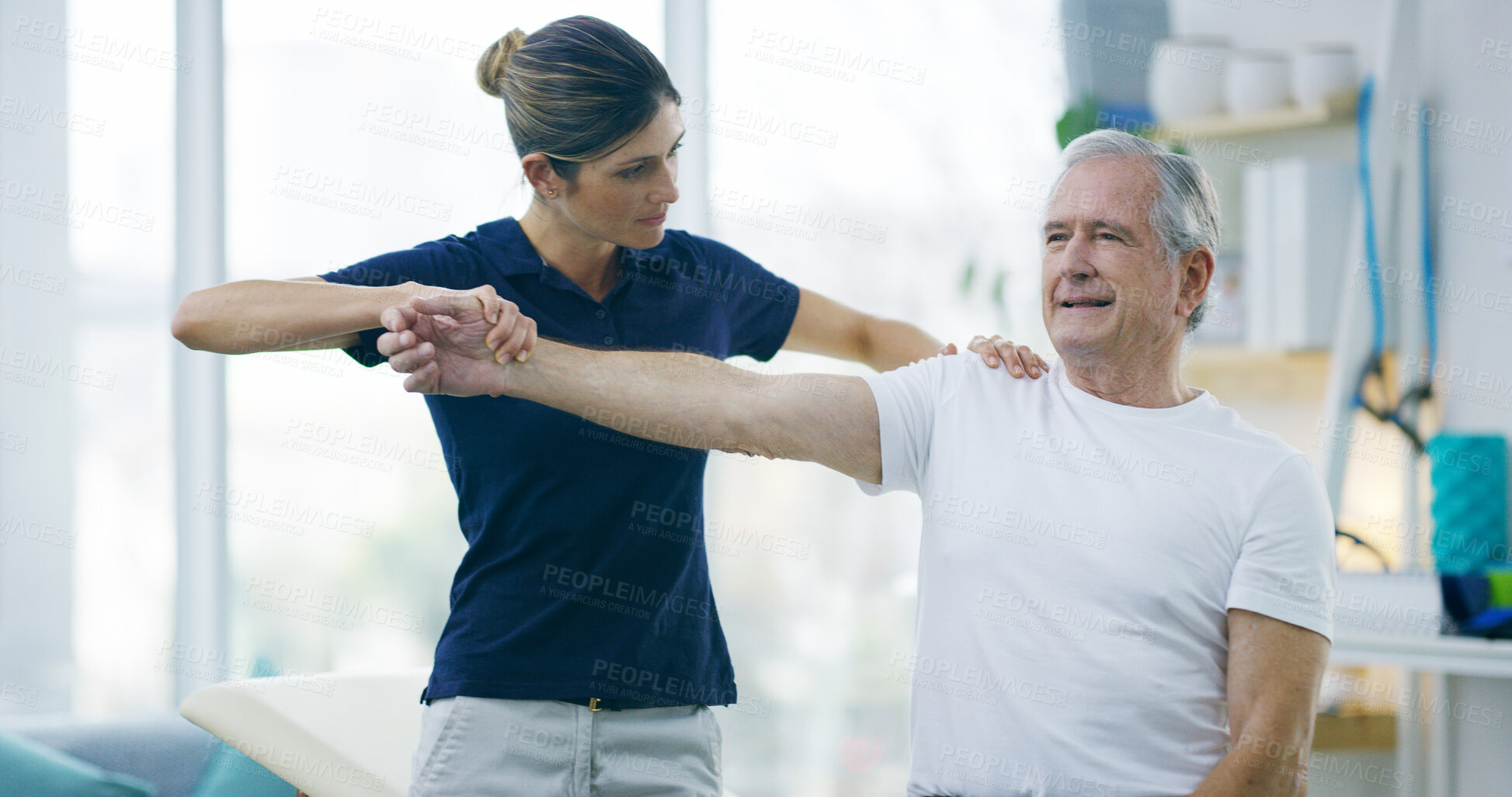 Buy stock photo Physiotherapy, woman or senior patient with shoulder pain for stretching, help or care in office. Chiropractor, elderly man or support in practice for rehabilitation, healing or arm exercise in exam