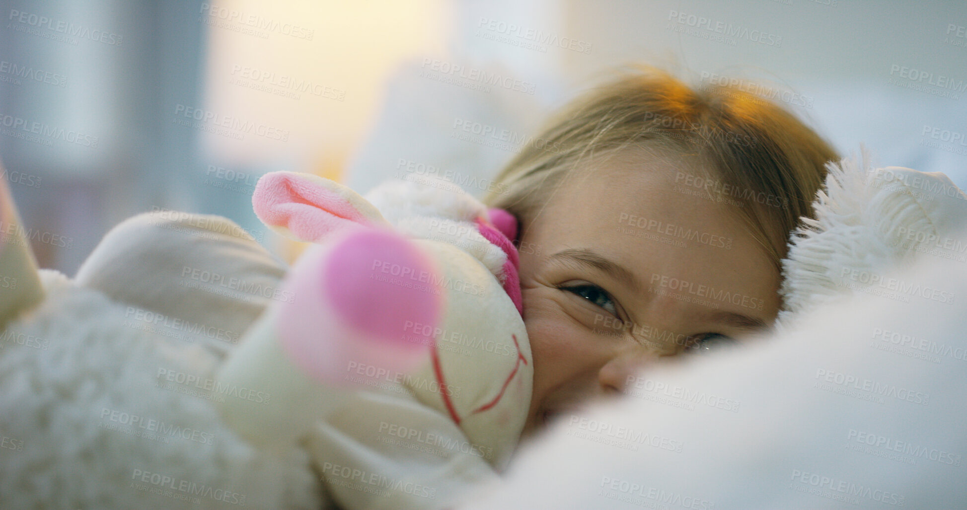 Buy stock photo Child, toy and cuddle as playful, excited and happy in home or bedroom for bonding, joy and care. Little girl, cheerful and comfortable with stuffed animal for relax, sleep and rest in house as kid