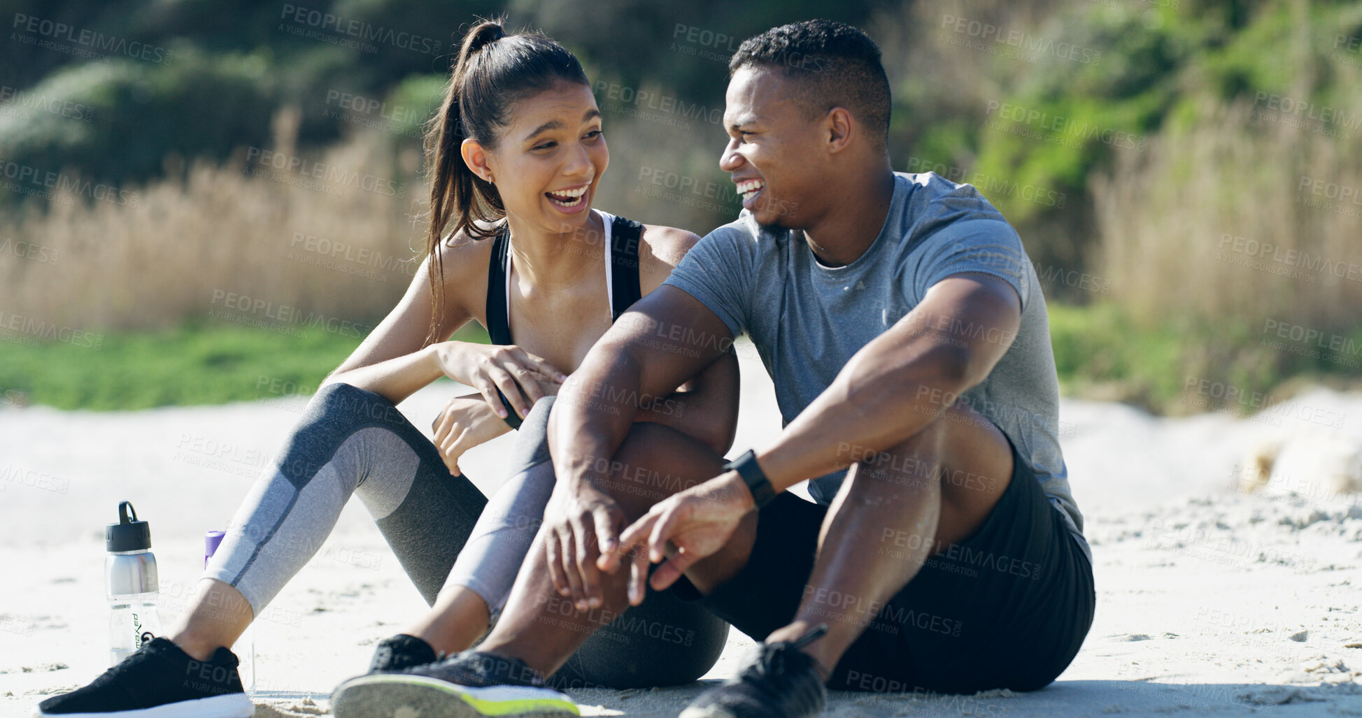 Buy stock photo Couple, beach and rest for break in training, fitness and recovery with laugh or joy as athlete. People, outdoor and happiness for support, sports and workout in running, bonding together and health