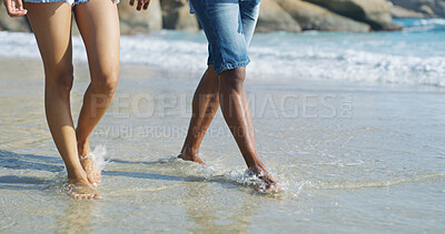 Buy stock photo Couple, feet and walking in water at beach for fresh air, travel adventure or tropical vacation with bonding. People, legs or exploring seaside for romantic date, holiday journey or together by ocean