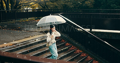 Buy stock photo Umbrella, stairs and woman in city walking in rain on vacation for exploring, adventure or fun. Winter season, steps and female person commuting in urban town on holiday or weekend trip in Japan.