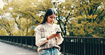 Japanese woman, walking and phone in street for online networking, dating app and happy with mobile chat. Person, smartphone and smile for social media post, notification or browsing internet in city