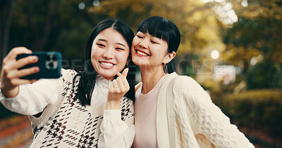 Buy stock photo Japanese, women and park with selfie for photography, vacation memory and bonding with hand sign. Happy people, friends and photographer with smile for social media, profile picture and finger heart