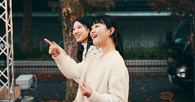 Buy stock photo Travel, pointing and Asian women in city, tourism and bonding with vacation, smile and sightseeing. Outdoor, friends and Japanese people on holiday, tourist and happy for trip, relationship and Japan