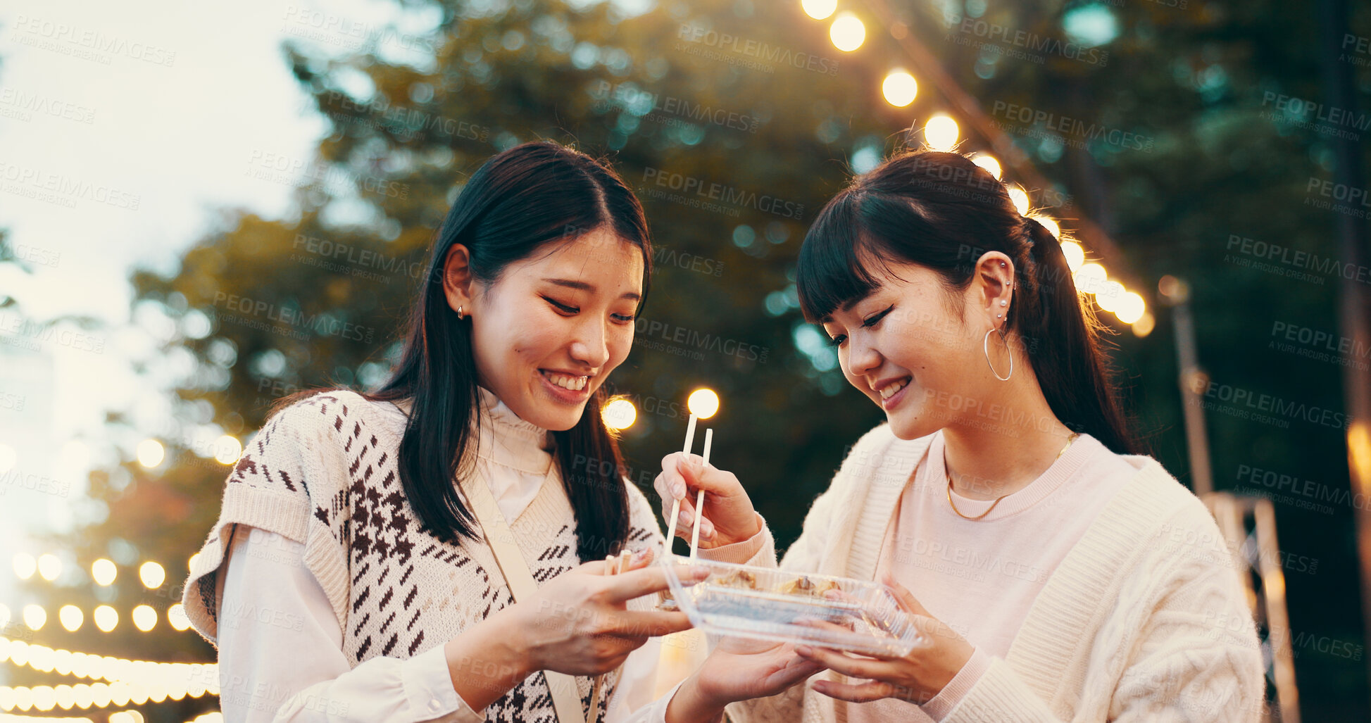 Buy stock photo City, asian women and happy with street food, students and snack for friends with dango, eating and travel. Outdoor, treats and smile for celebration of reunion, people or sharing of cuisine in Japan