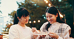 City, asian women and students with candy, smile and snack for friends with dango, eating and travel. Outdoor, treats and sweets for celebration of reunion, happy and sharing of food in Japan