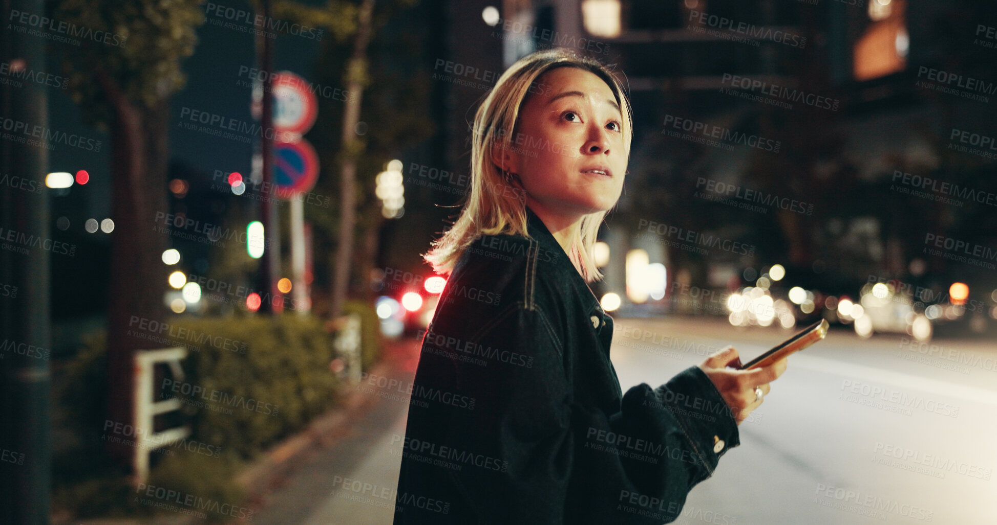 Buy stock photo Night, travel and girl in city with phone, connection or checking online location for public transport schedule. Smartphone, search and Japanese woman in street with mobile app for late urban commute