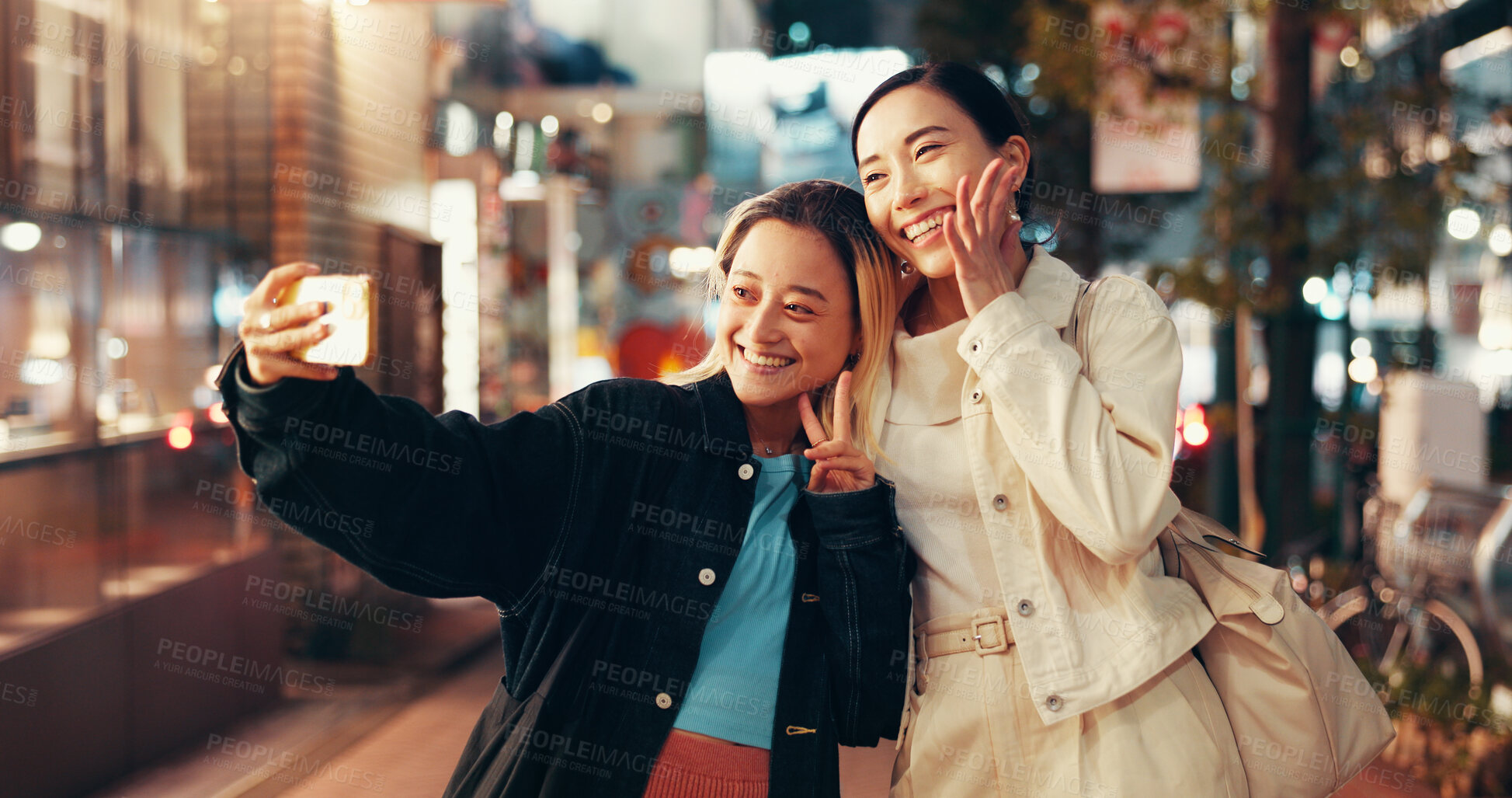 Buy stock photo Happy, asian women and night with peace sign for selfie, photography or picture in Toky city. Japan, female people or friends with smile or emoji for travel, memory or capture moment in an urban town