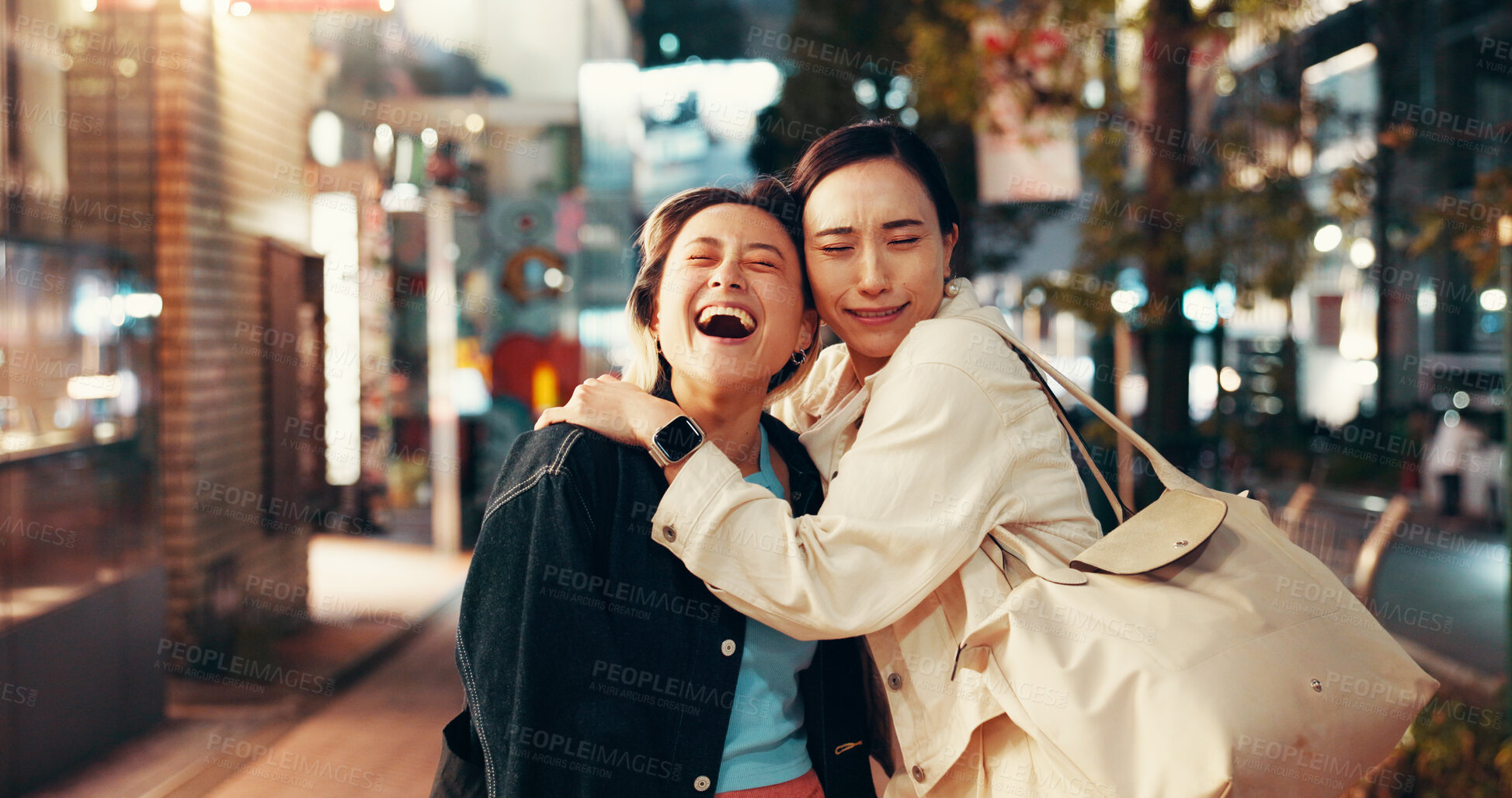 Buy stock photo Happy, asian women and night with hug in city for love, care or bonding together in an urban town. Japan, female people or friends with smile in late evening for travel or fun moment in Tokyo street