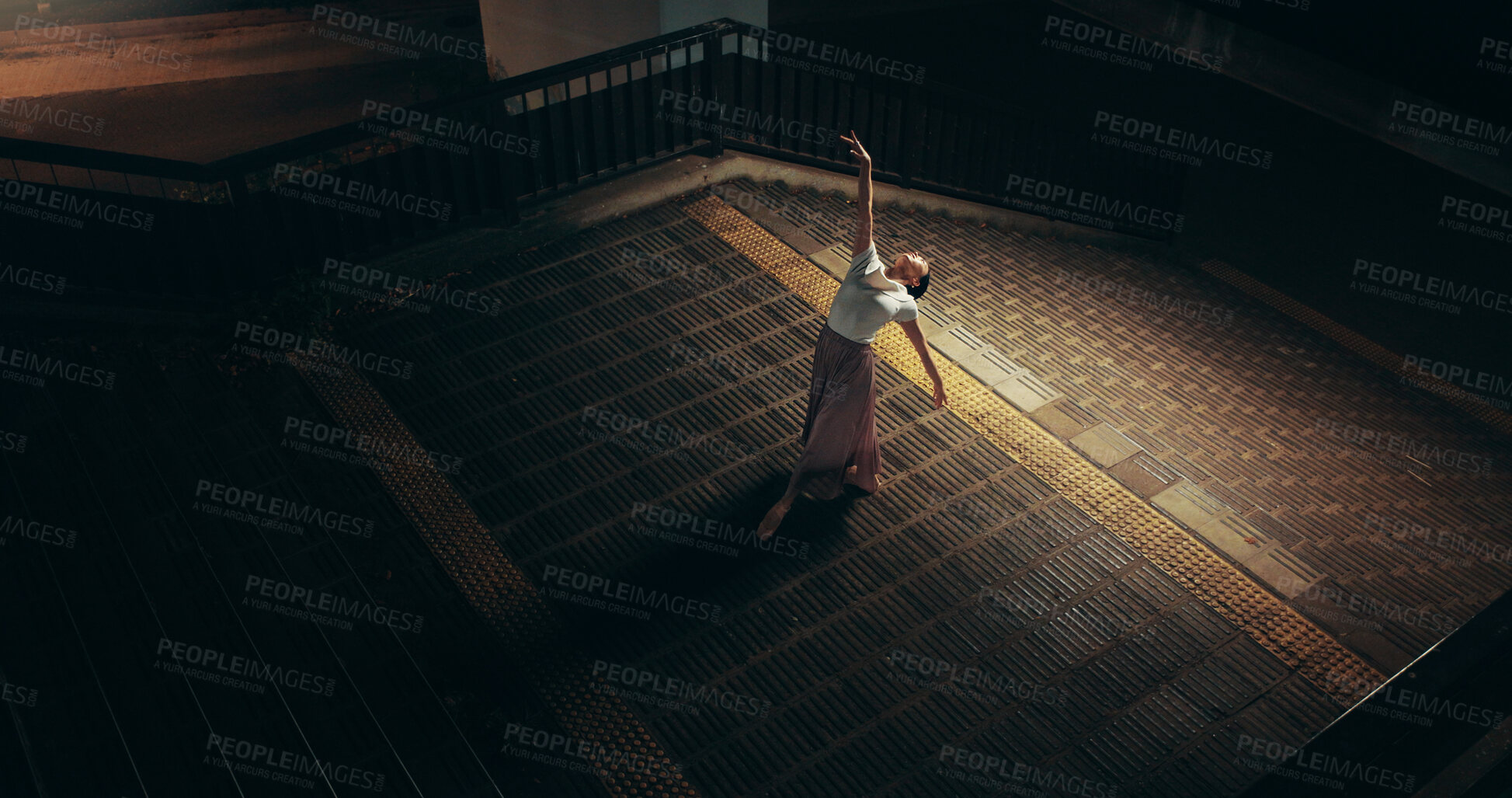 Buy stock photo Ballet, dance and above with Japanese woman in city for balance, theater and elegant performance. Talent, artist and feminine with person or ballerina dancer at night for recital, music or practice 