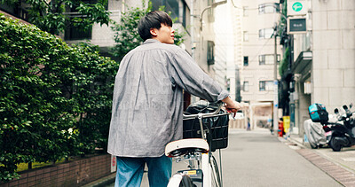 Buy stock photo Walking, city and back of Asian man with bicycle for commute to university, college and school. Travel, sightseeing and person on bike for trip, sustainability and eco friendly transport in Japan