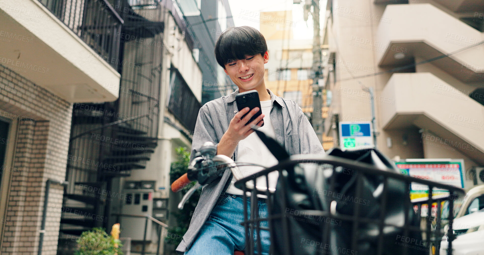 Buy stock photo Phone, bicycle and smile with Japanese man in city for location, digital map and travel. Social media, cycling and mobile app with person and bike in japan for networking, connection and adventure