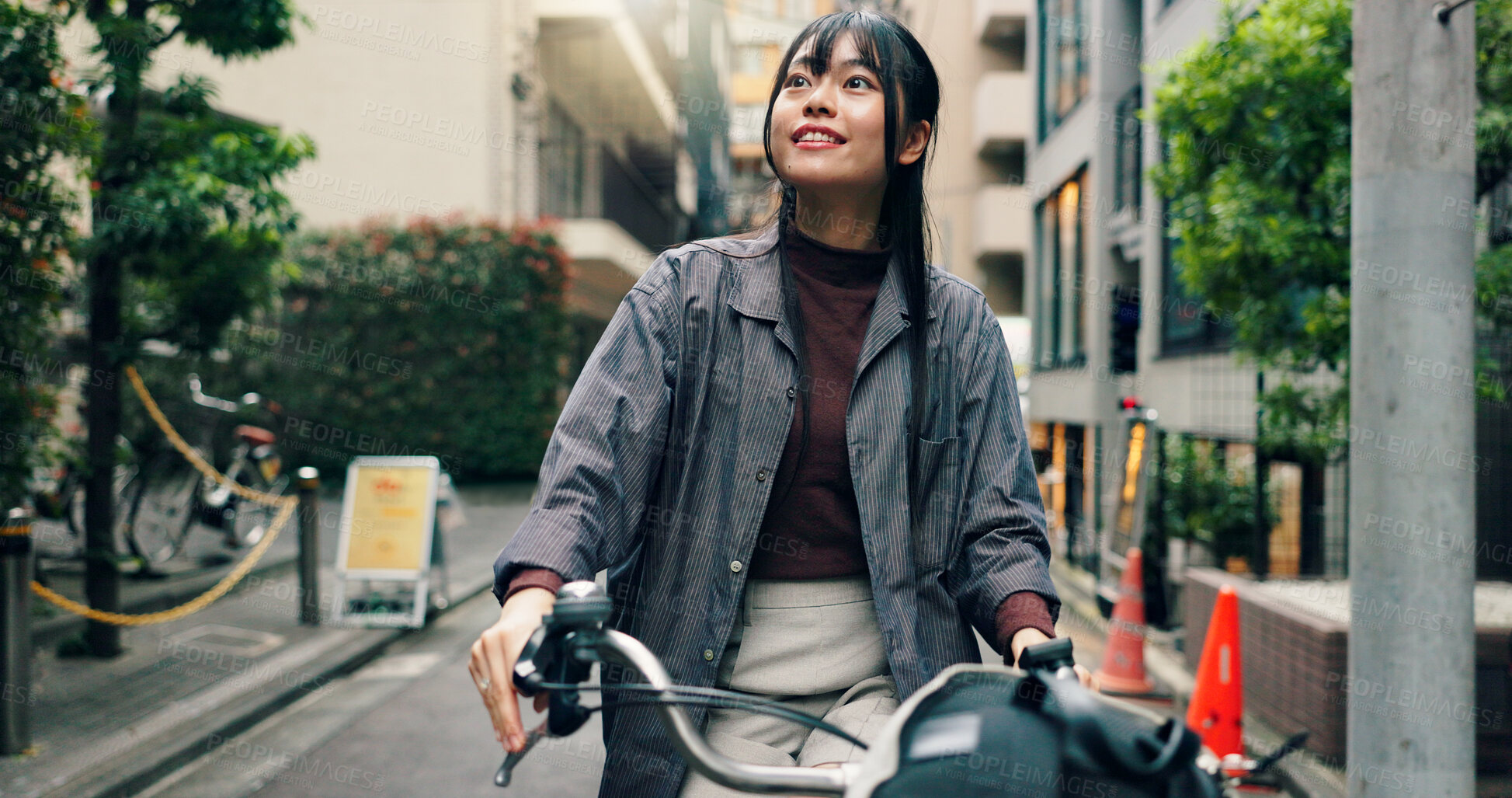 Buy stock photo Travel, buildings and Asian woman on bicycle in city for morning commute, adventure or journey outdoors. Location, cycling and person on bike for trip, sustainable and eco friendly transport in Japan