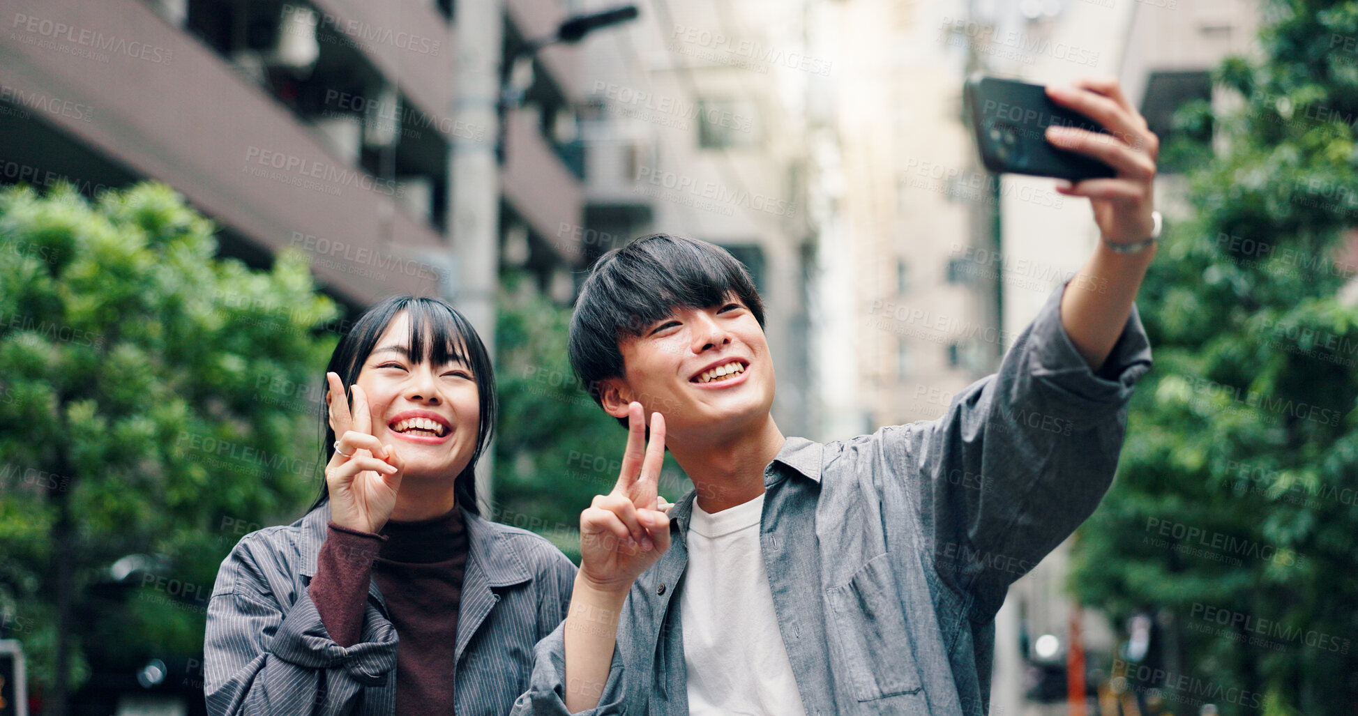 Buy stock photo Happy, asian couple and city with peace sign for selfie, photography or memory together in street or road. Japanese, man and woman with smile for moment, capture or picture in an urban town in Tokyo