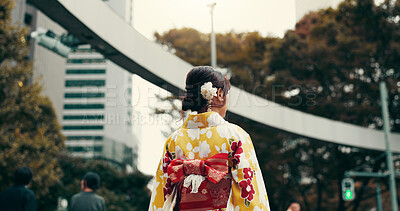 Buy stock photo Street, culture and woman in city with kimono, morning commute and sightseeing in traditional clothes from back. Explore, discover and girl with Japanese fashion, walking or travel on urban adventure