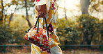 Asian woman, hands and walking with kimono or bag in nature for travel, tradition or culture. Japan, closeup and strolling with stylish fashion, luggage or handbag for tourism or commute at park