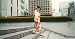 City, walking and woman on steps with kimono, morning commute and sightseeing in traditional clothes. Explore, discover and girl with Japanese fashion, culture or urban stairs on travel adventure