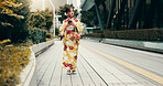 Walking, cellphone and Japanese woman in city in kimono for travel on vacation, holiday or getaway. Phone, commuting and person in urban town for adventure on weekend trip with cultural fashion.