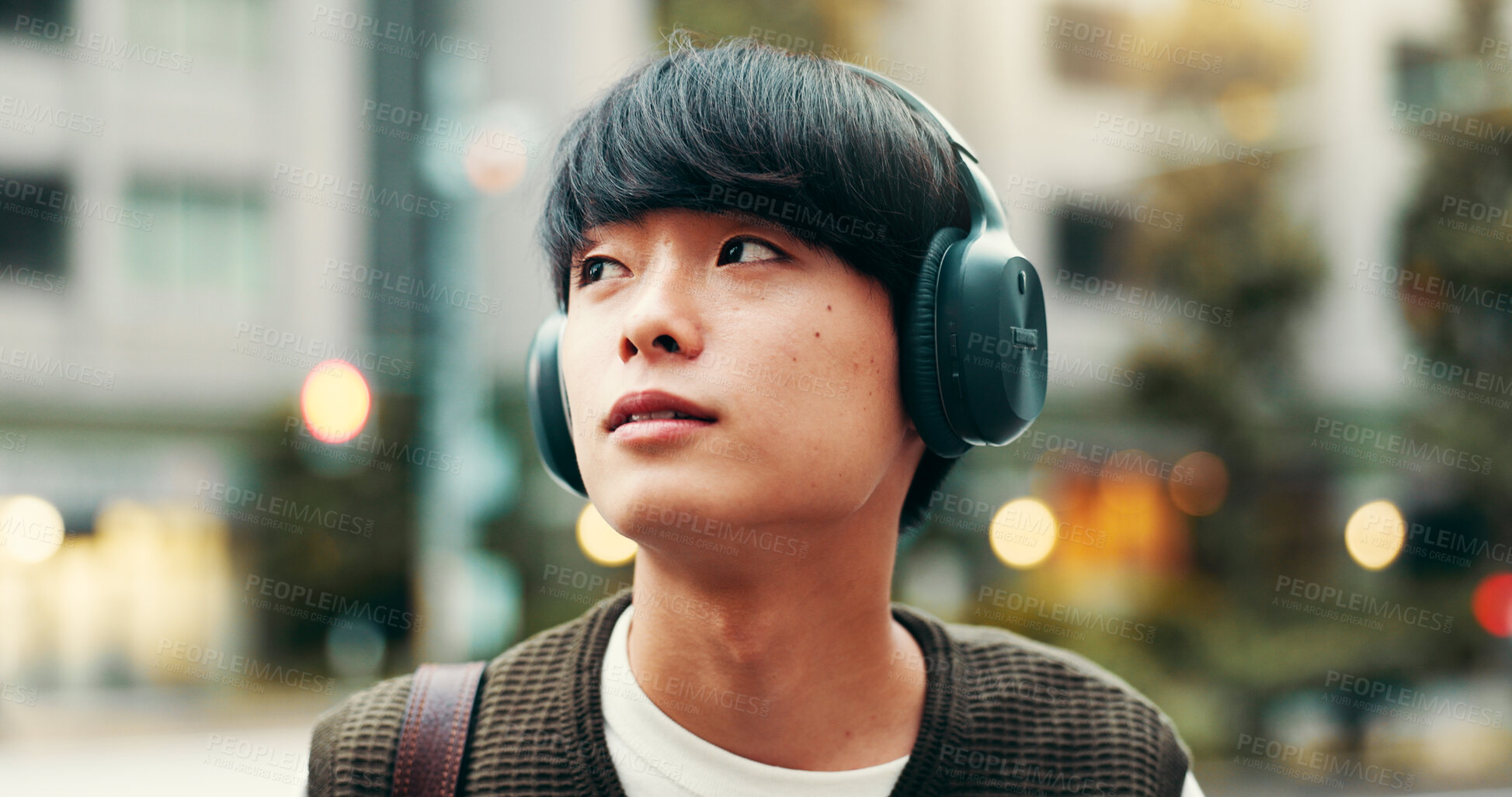 Buy stock photo Japanese man, thinking and outdoor with podcast, headphones and vision in city street or metro. Male person, listening and music as engineering student in university for planning, tourism and commute