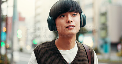 Buy stock photo Japanese man, thinking and outdoor with headphones, vision and pride in city street or metro. Male person, happiness and music as engineering student in university with planning, tourism and commute