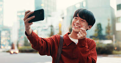 Buy stock photo Japanese man, selfie and smile in street for social media, post or memory as university student. Male person, outdoor and city with photography, pride or finger heart for networking or online profile