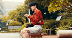 Phone, reading and relax with Japanese man in college for student portal, education and University website. Social media, networking and research with asian person on campus for streaming and chat 