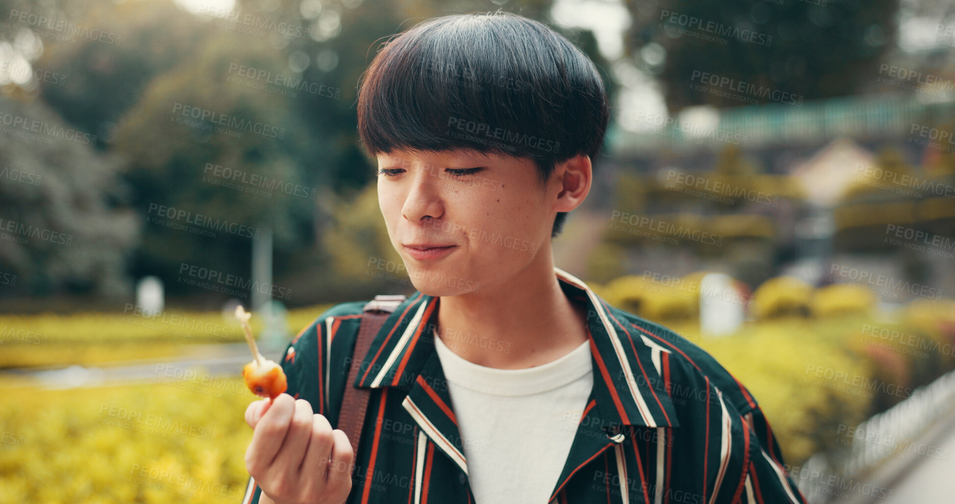 Buy stock photo Street food, park and Japanese man with eating, meal and asian snack on trip outdoor. Travel, dumpling and hungry student on summer break and vacation in Tokyo with lunch and traditional cuisine