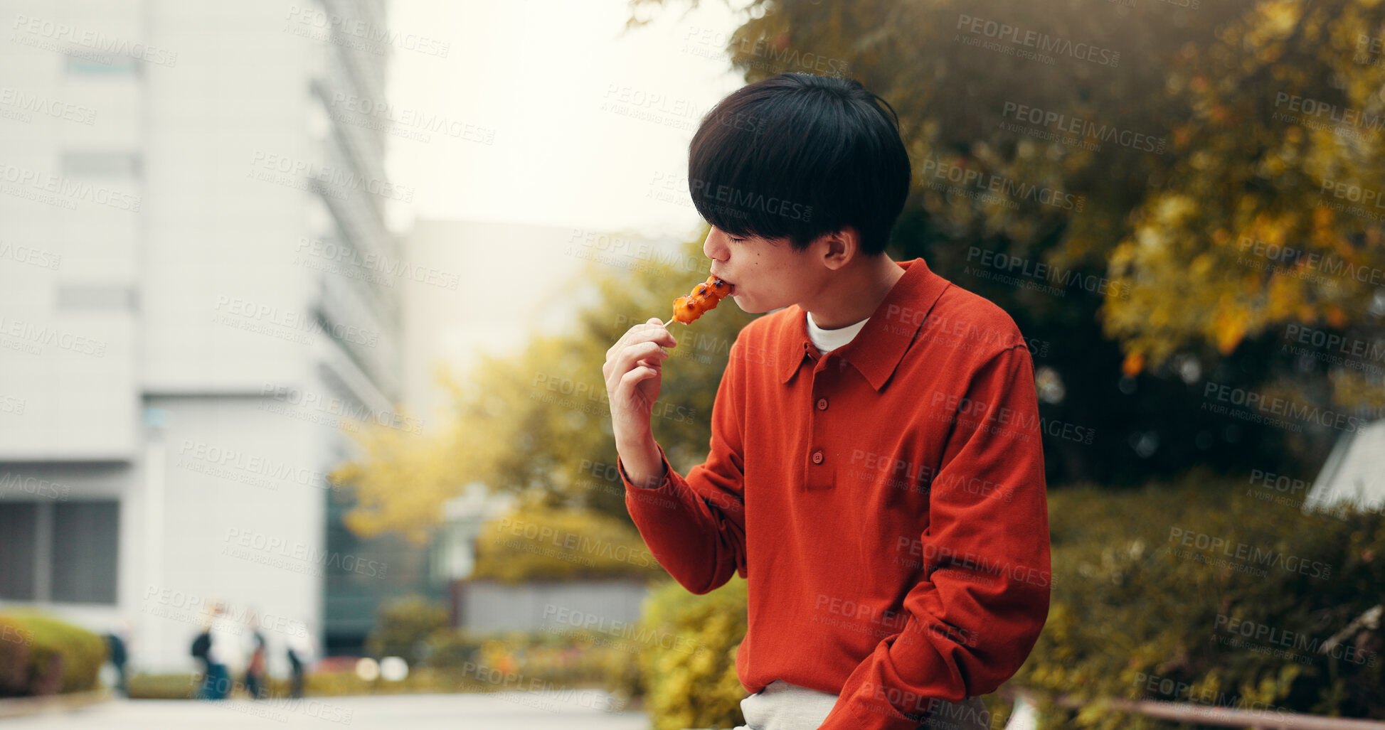 Buy stock photo Street food, city and Japanese man with eating, meal and asian snack on trip outdoor. Town, dumpling and hungry student on summer break and vacation in Tokyo with lunch and traditional cuisine