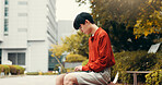 Asian man, student and laptop in city with typing, planning and creative writing for travel blog in Japan. Japanese person, computer or relax in Tokyo with social media post, journal editing or email