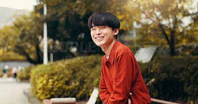 Buy stock photo Man, portrait and outdoor trip to Japan, happy tourist and relax on bench in nature for peace. Male person, travel and journey to holiday destination for laughing, funny humor and weekend for break