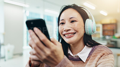 Buy stock photo Headphones, woman and smile with phone in home for watching video, social media scroll or radio app. Japanese person, smartphone and happy for listening to music, audio playlist and streaming service