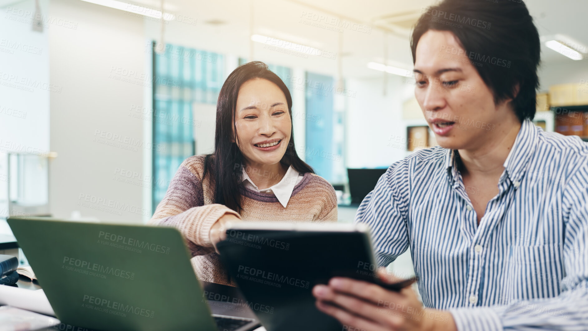 Buy stock photo Japanese man, woman and tablet in coworking for collaboration, feedback and review on laptop. Business people, teamwork and technology in brainstorming, discussion or project management as colleagues