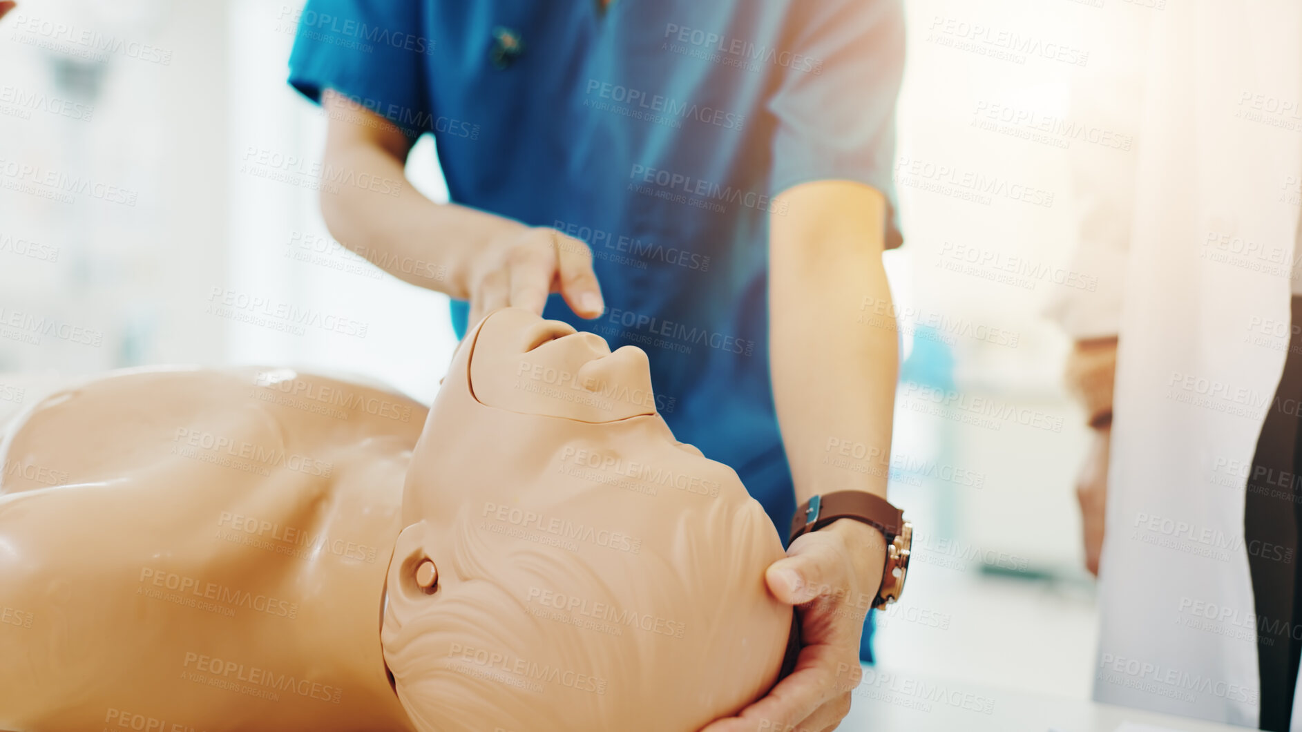 Buy stock photo Hands, medical students and first aid for emergency, education and practical training in hospital. People, learning and healthcare in simulation for manikin, knowledge and cpr with dummy in Japan