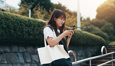 Buy stock photo Woman, phone and relax in city with social media, text message and weekend planning in Osaka. Japanese girl, student and mobile in park for travel blog, connectivity and networking on study break